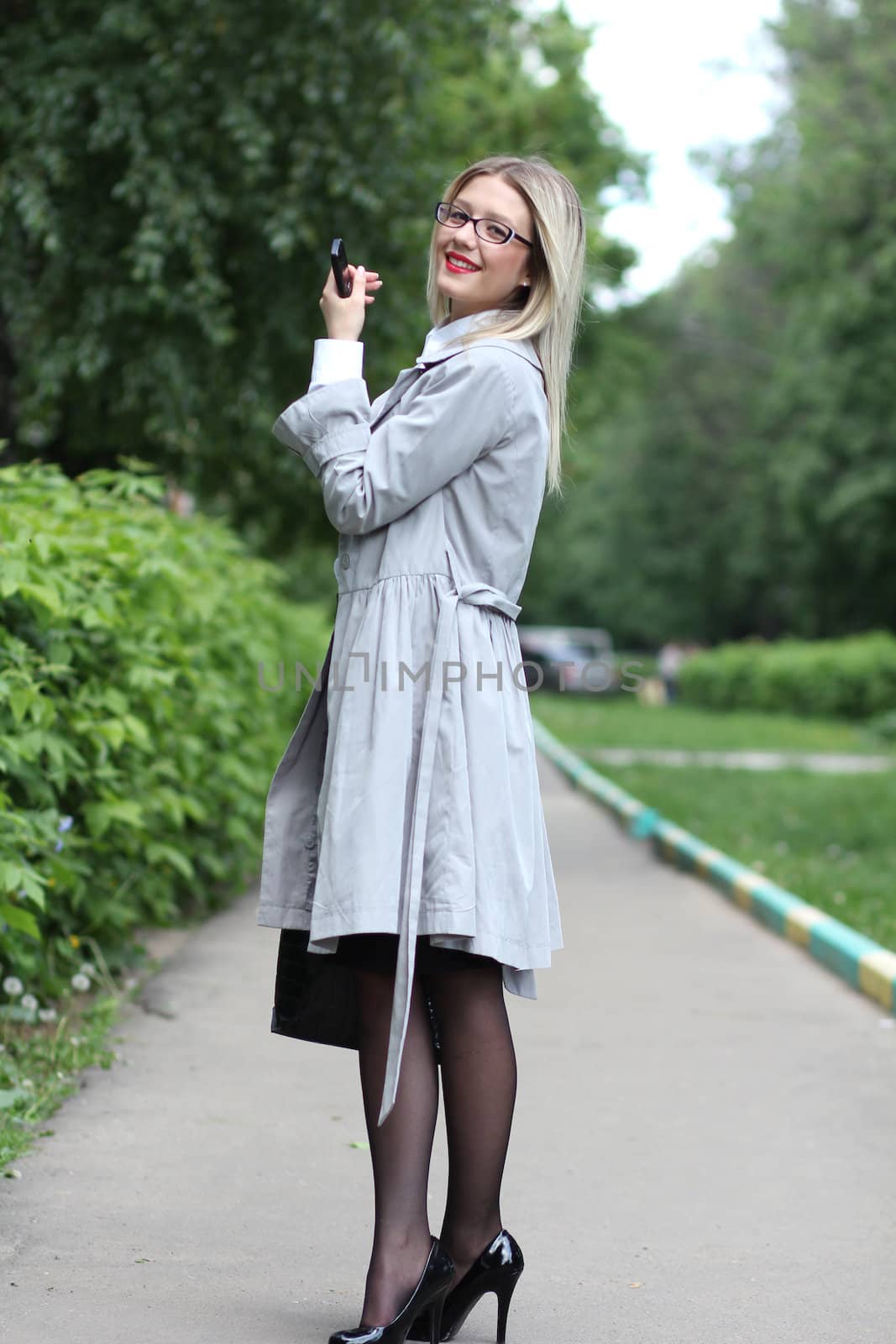 beautiful young woman business woman in a gray cloak