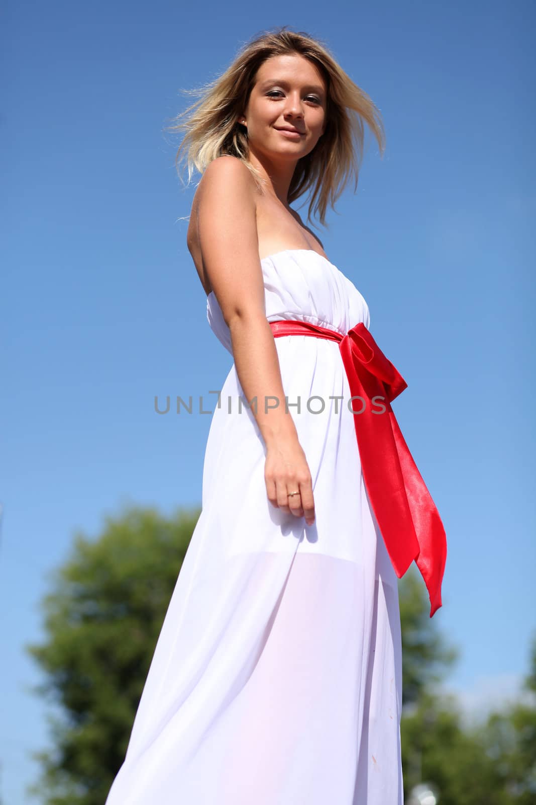 Lady in white dress in the street summer