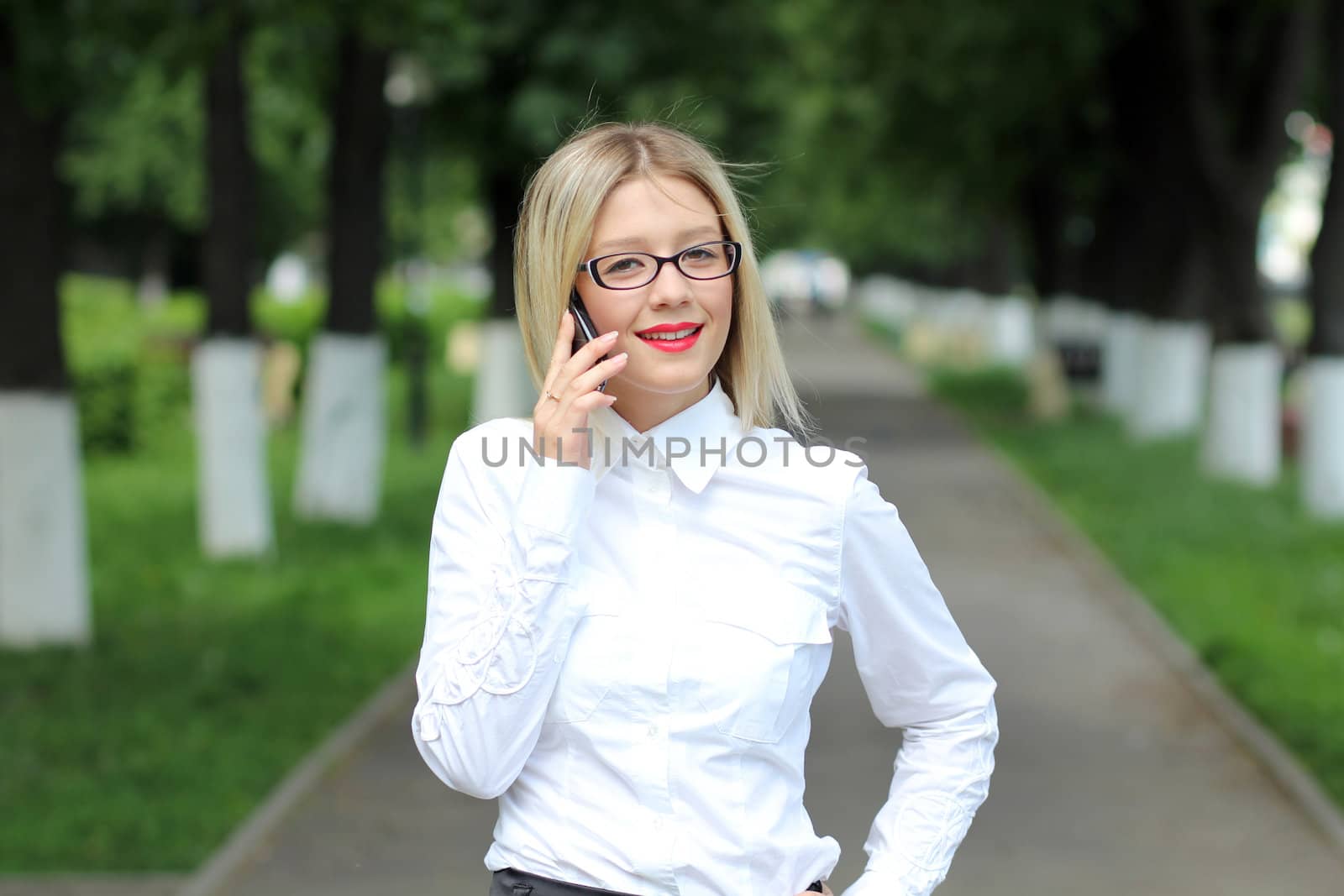 Happy young lady talking on mobile phone