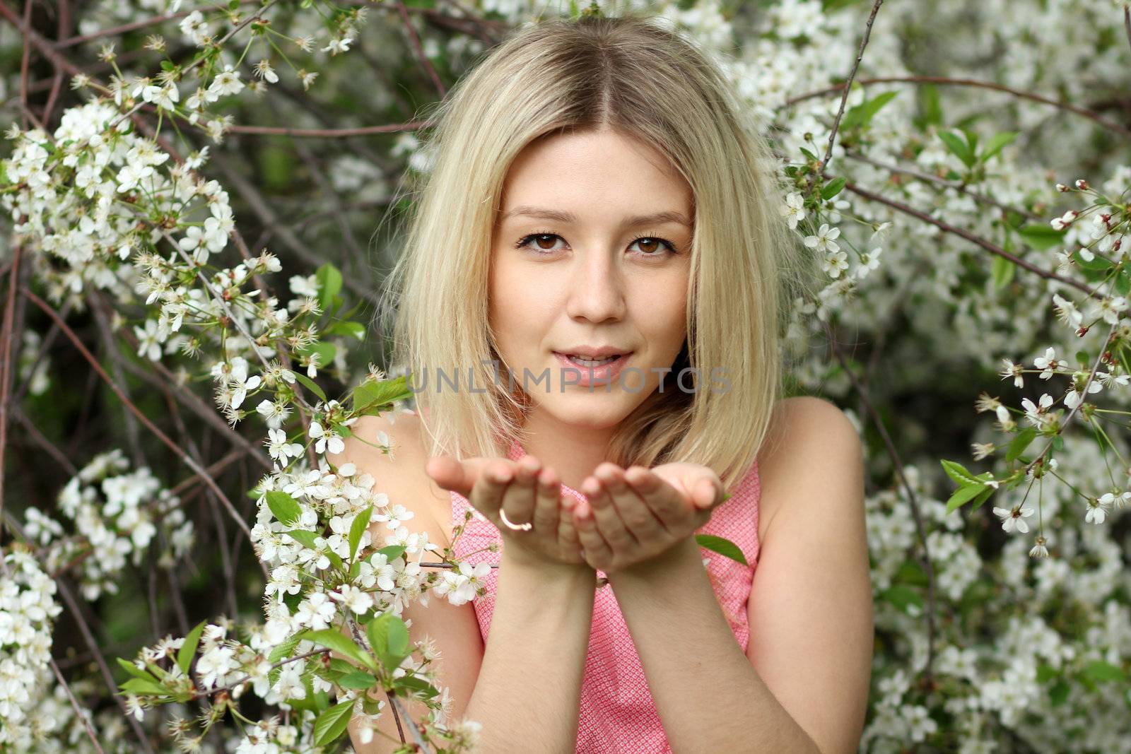 Portrait of beautiful blond in spring blossom