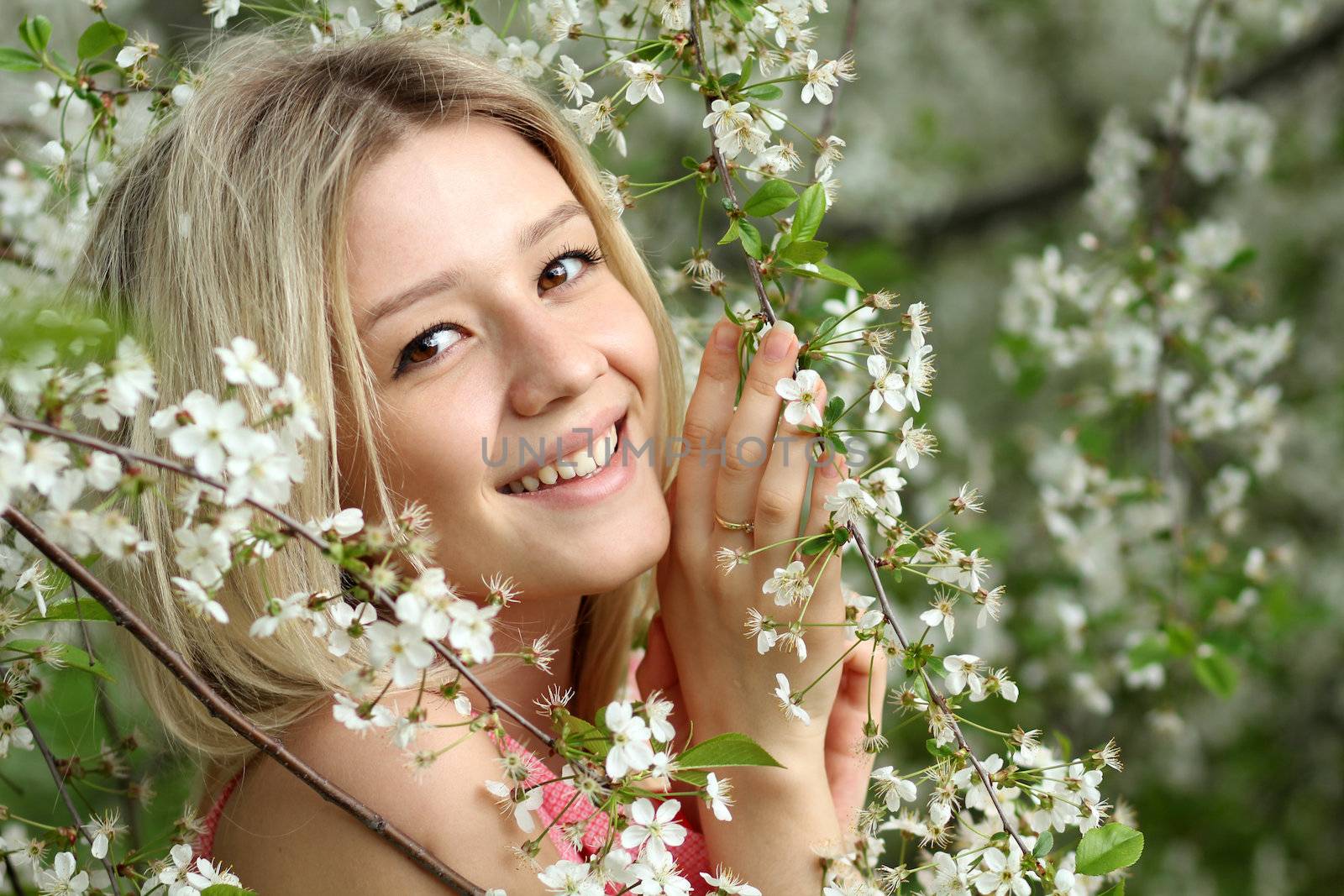 Portrait of beautiful blond in spring blossom