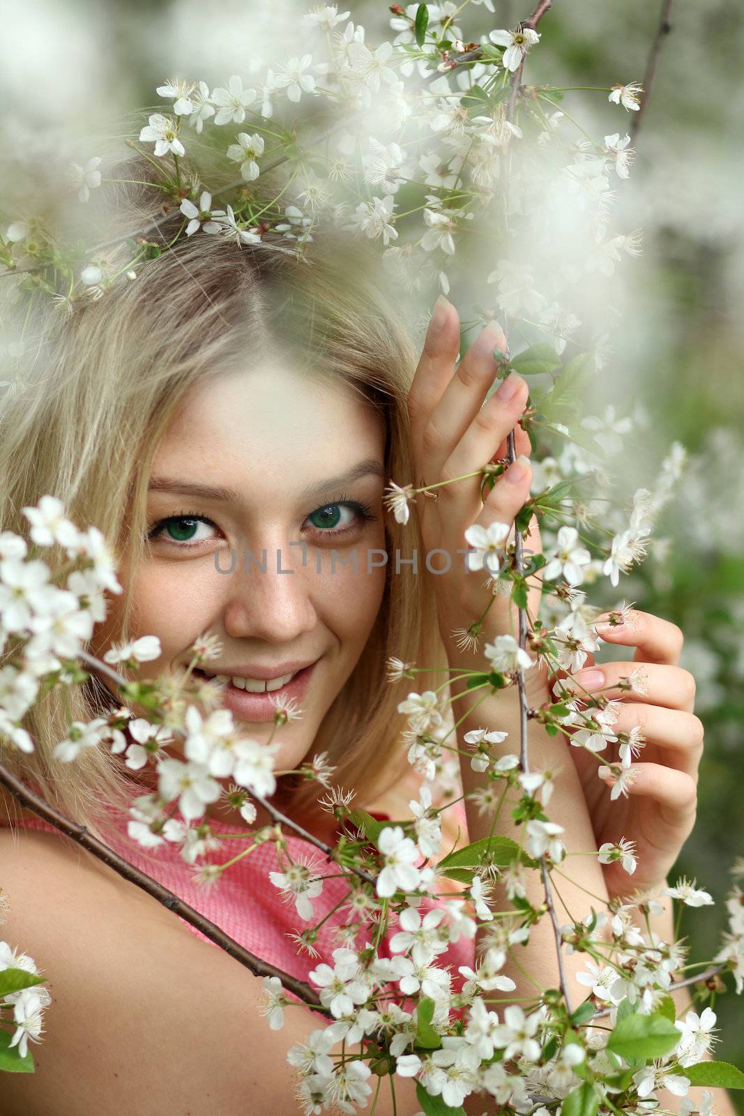 Portrait of beautiful blond in spring blossom