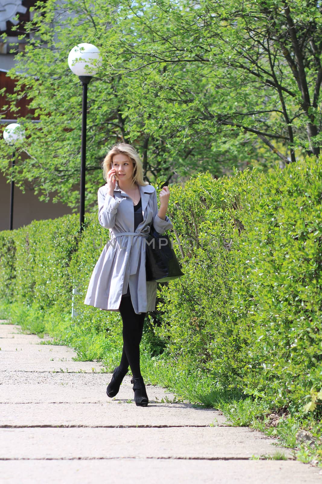 beautiful young woman business woman in a gray cloak