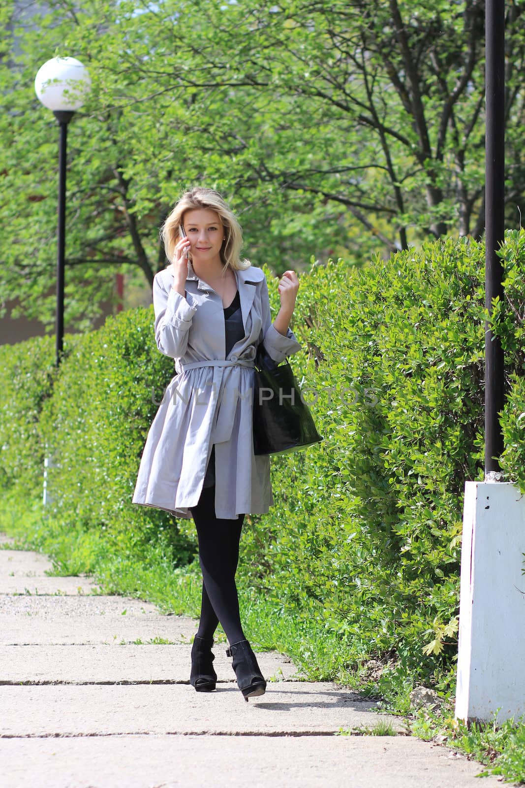 Happy young lady talking on mobile phone