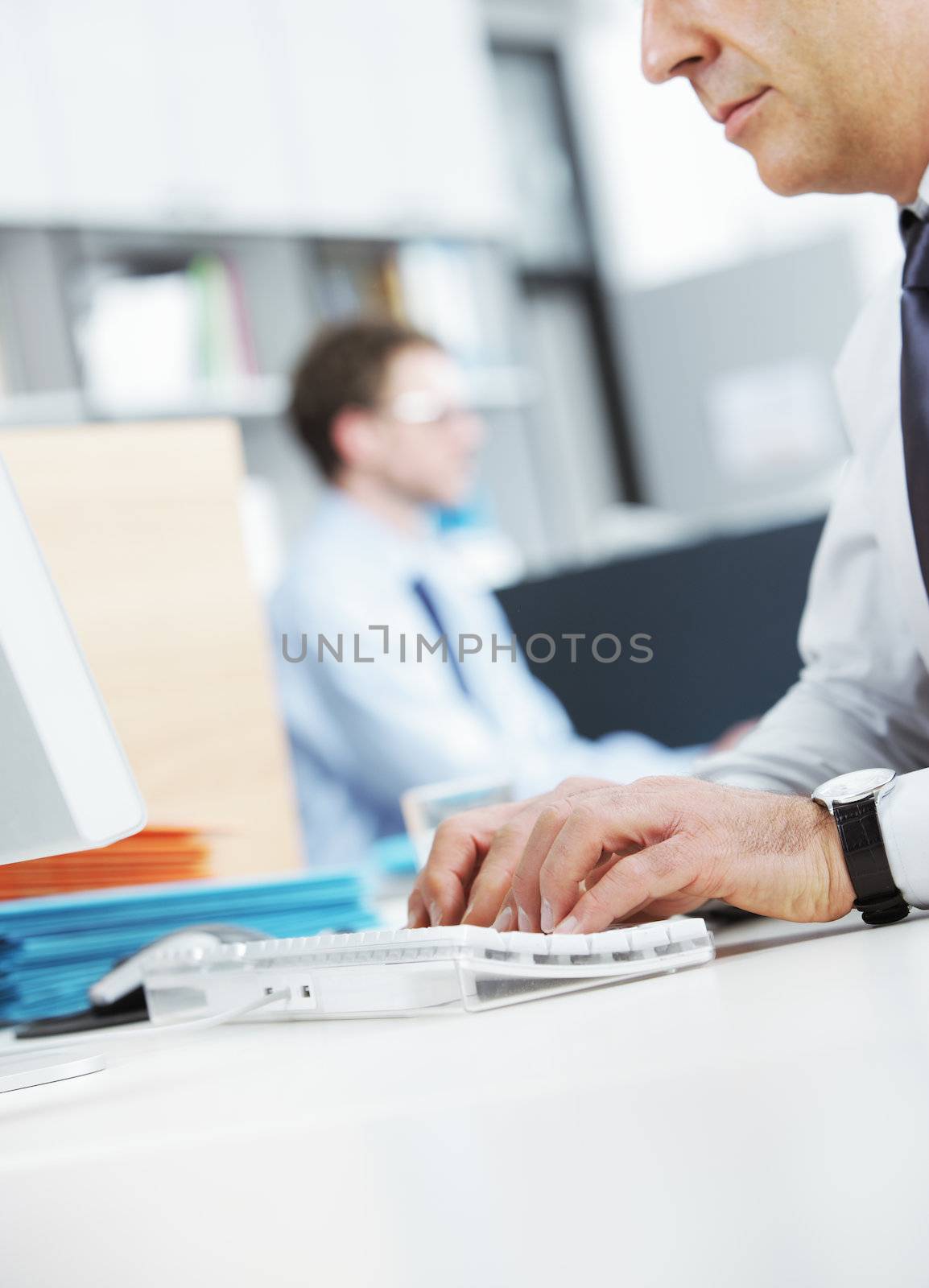 Mature businessman at desk working on computer