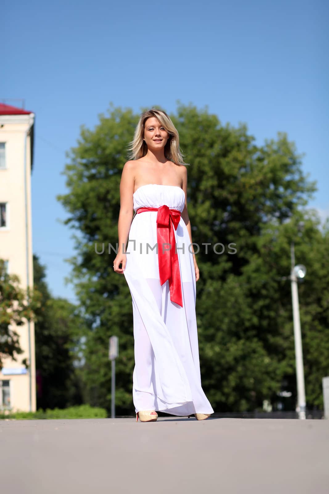 Lady in white dress in the street summer