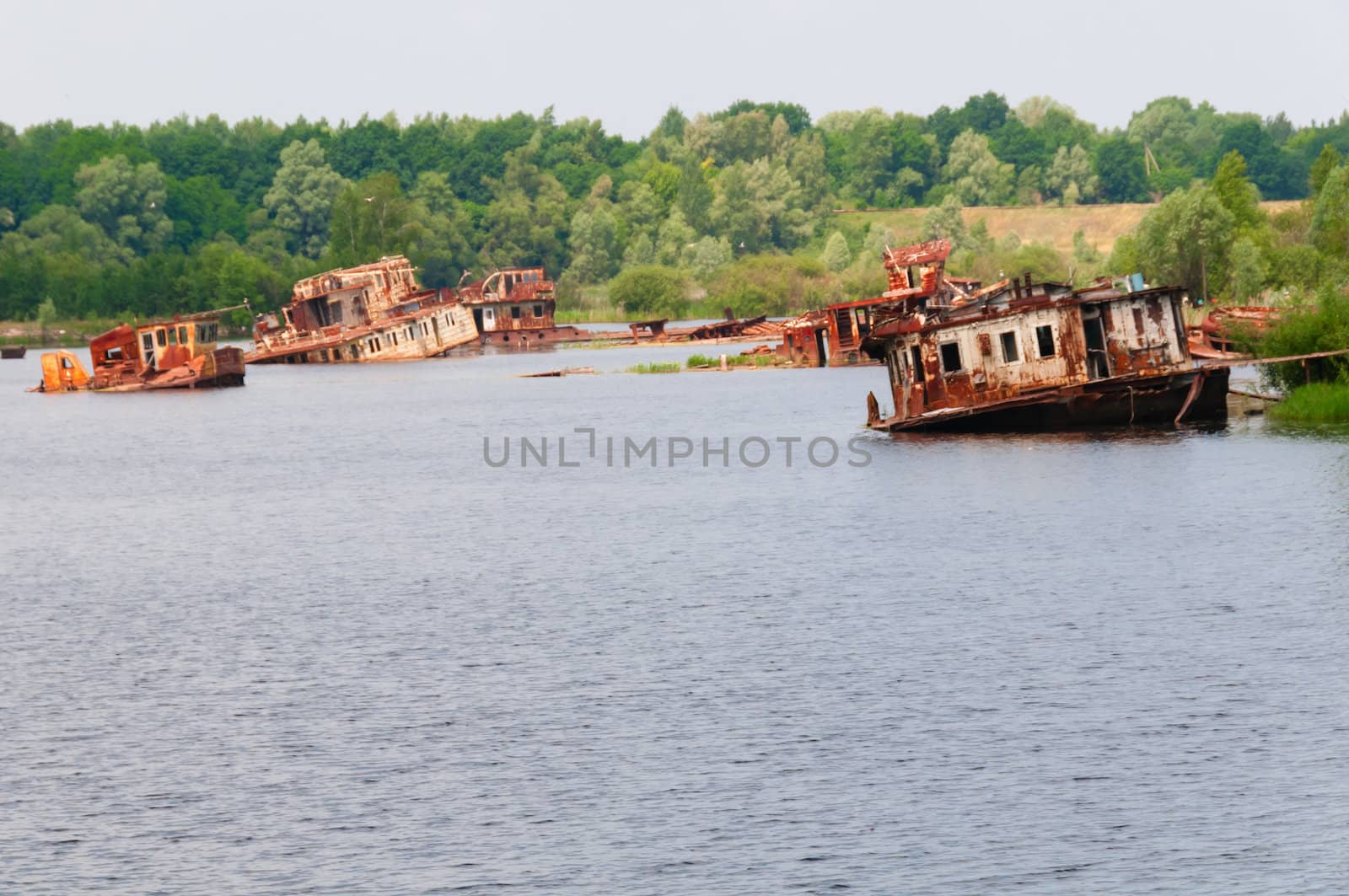 Many wrecked abandoned ship on a river after nuclear disaster in Chernobyl, Ukraine
