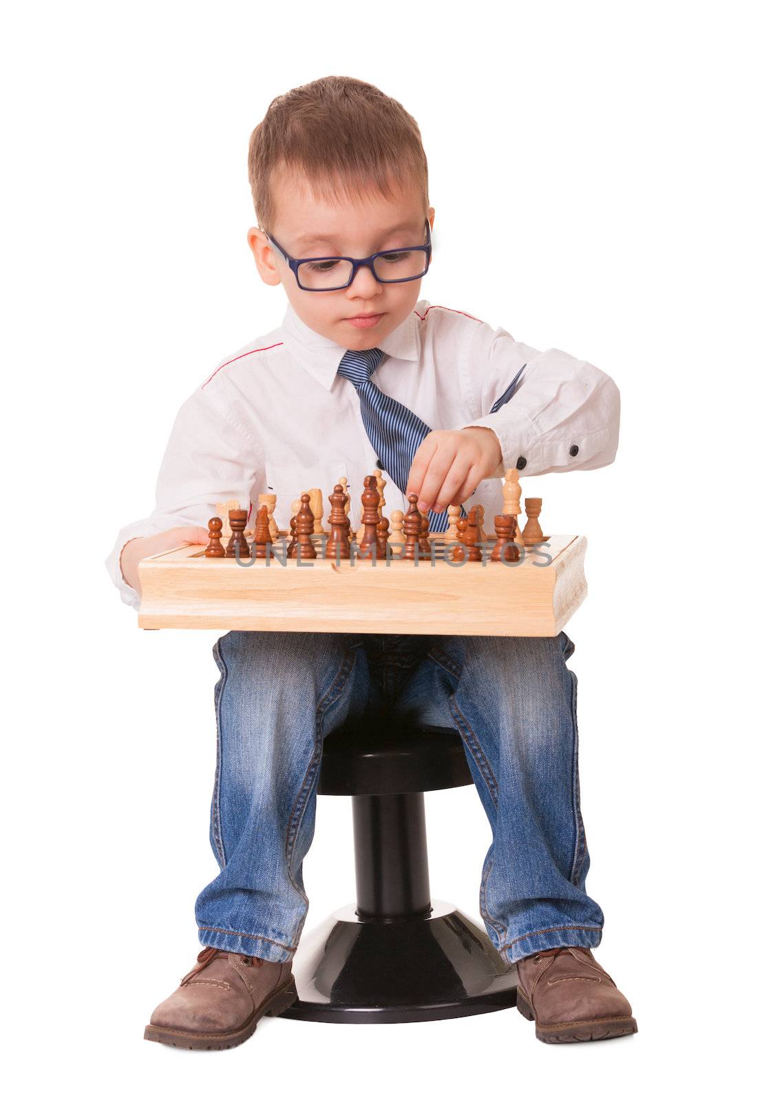 Serious kid playing chess, isolated on white background. 