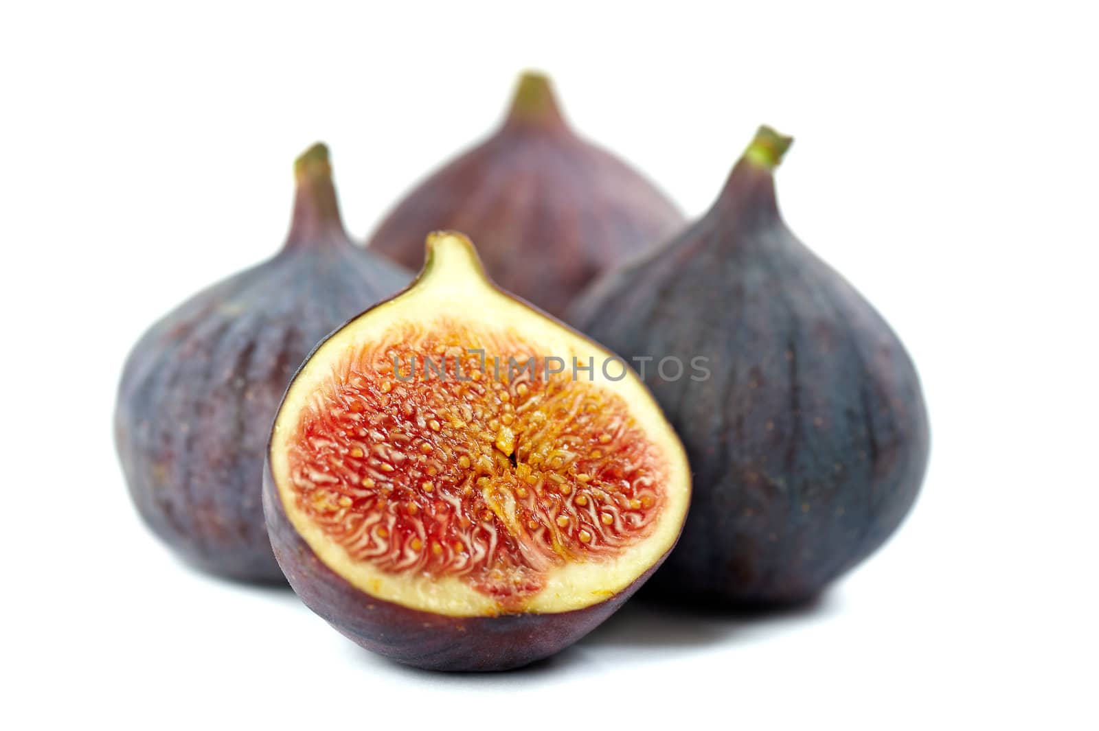 Whole and two half figs isolated on white