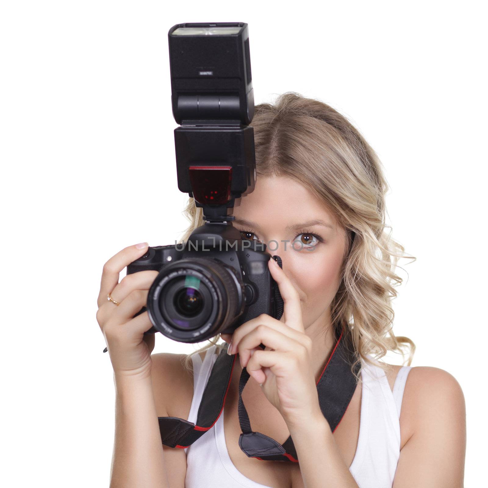 Cheerful woman shooting with a camera against white background