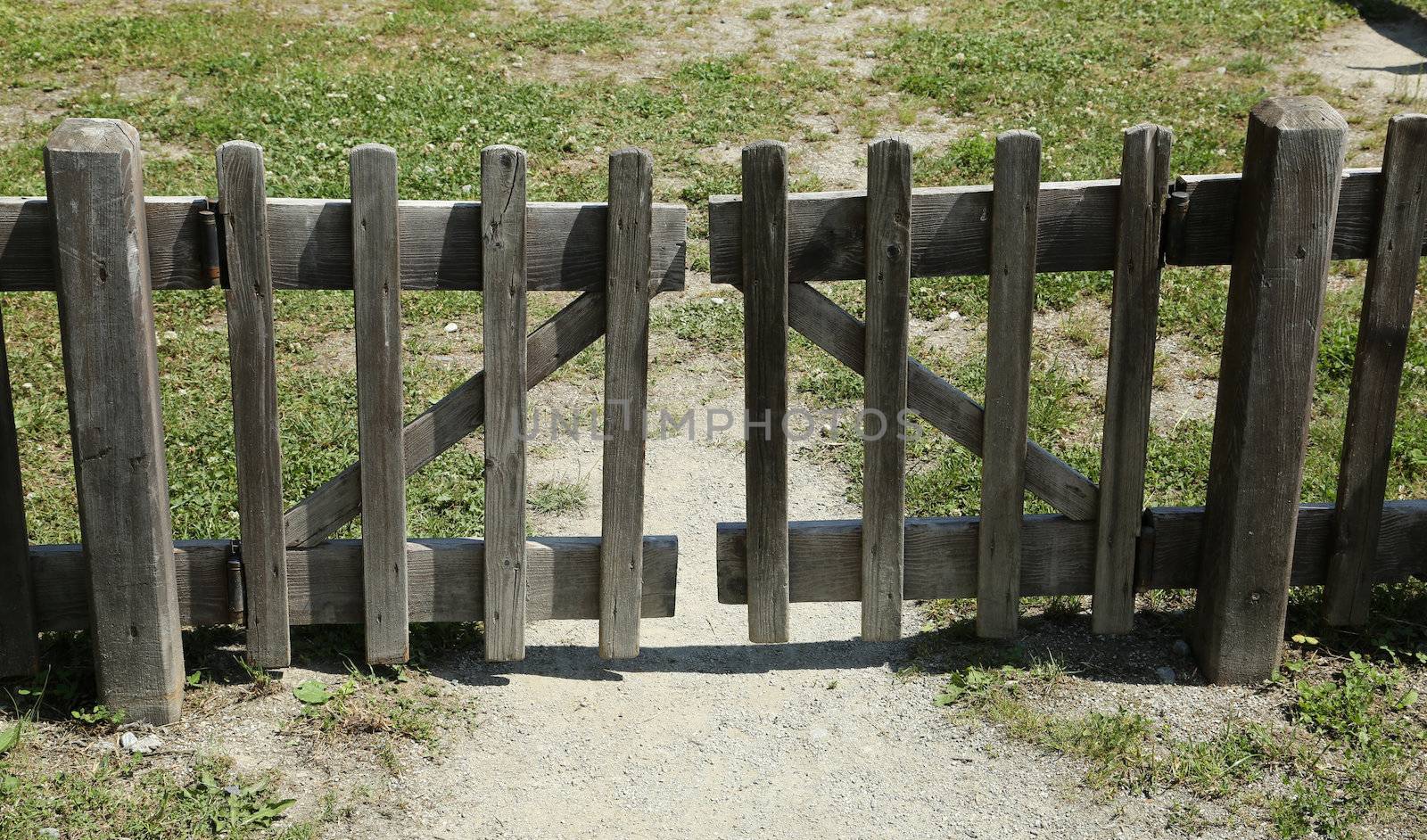 Closed brown wooden hence towards a grass field