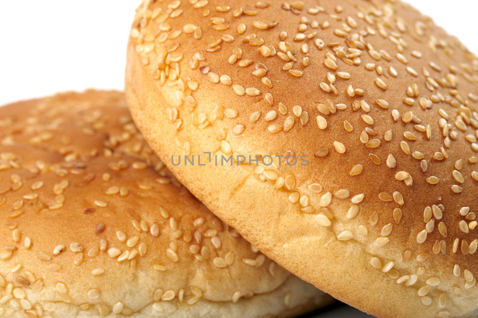 Closeup of two appetizing fresh burger buns on white background