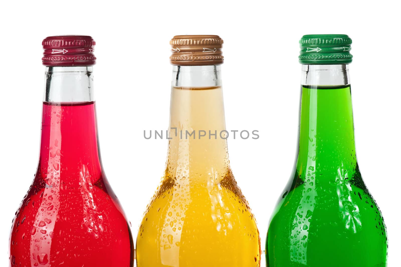 Assortment of cold bottles of pop or coolers on white background
