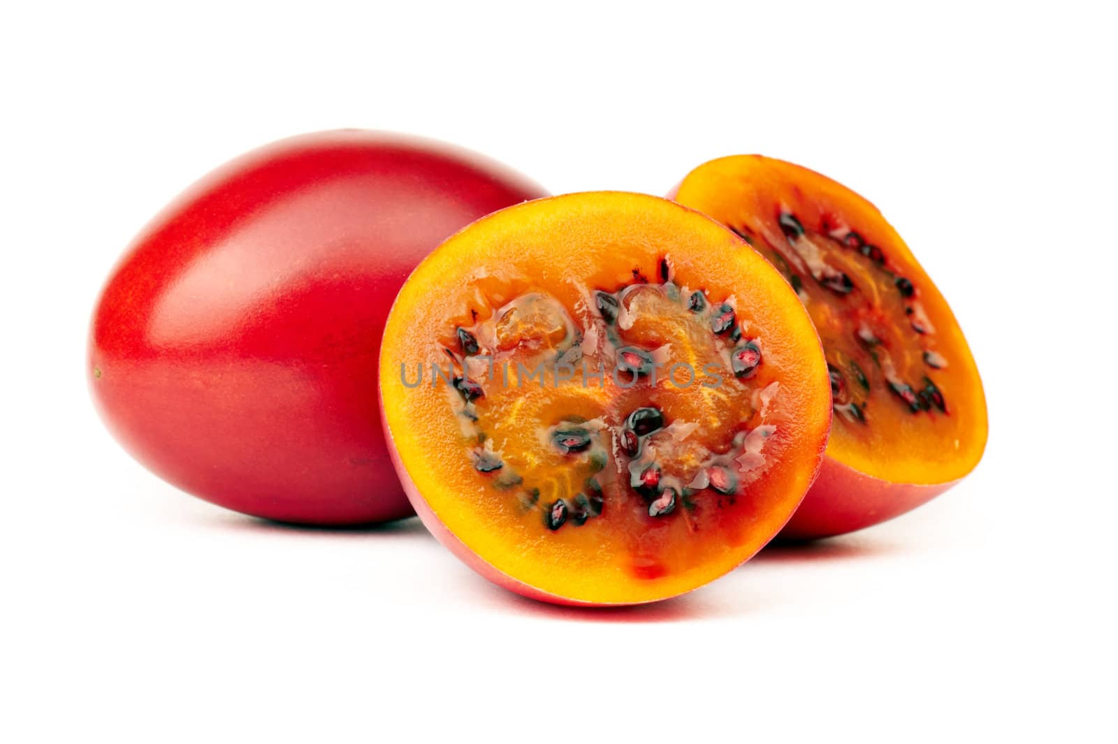 Tamarillo, whole and cut half-and-half on white background