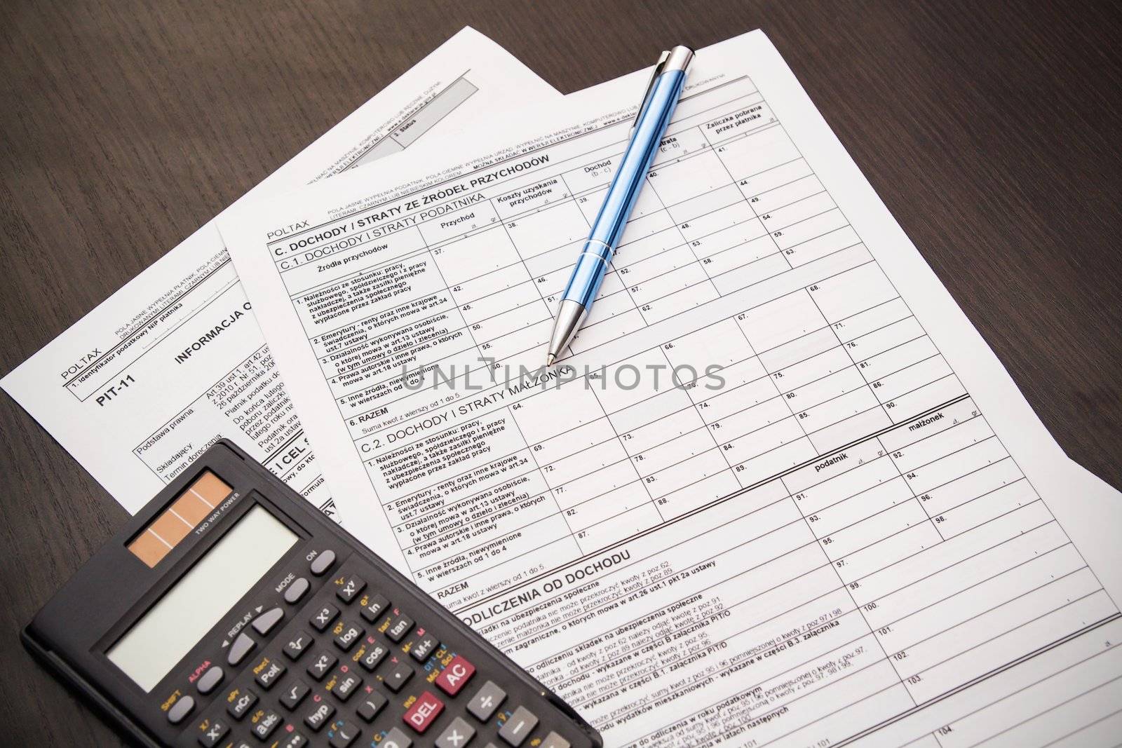 Polish tax form with pen and calculator on desk by simpson33