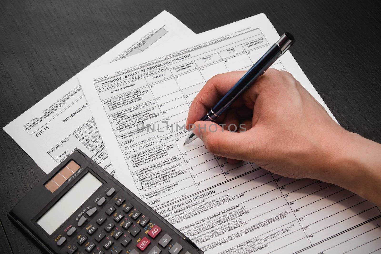 Man fills out polish tax form by simpson33