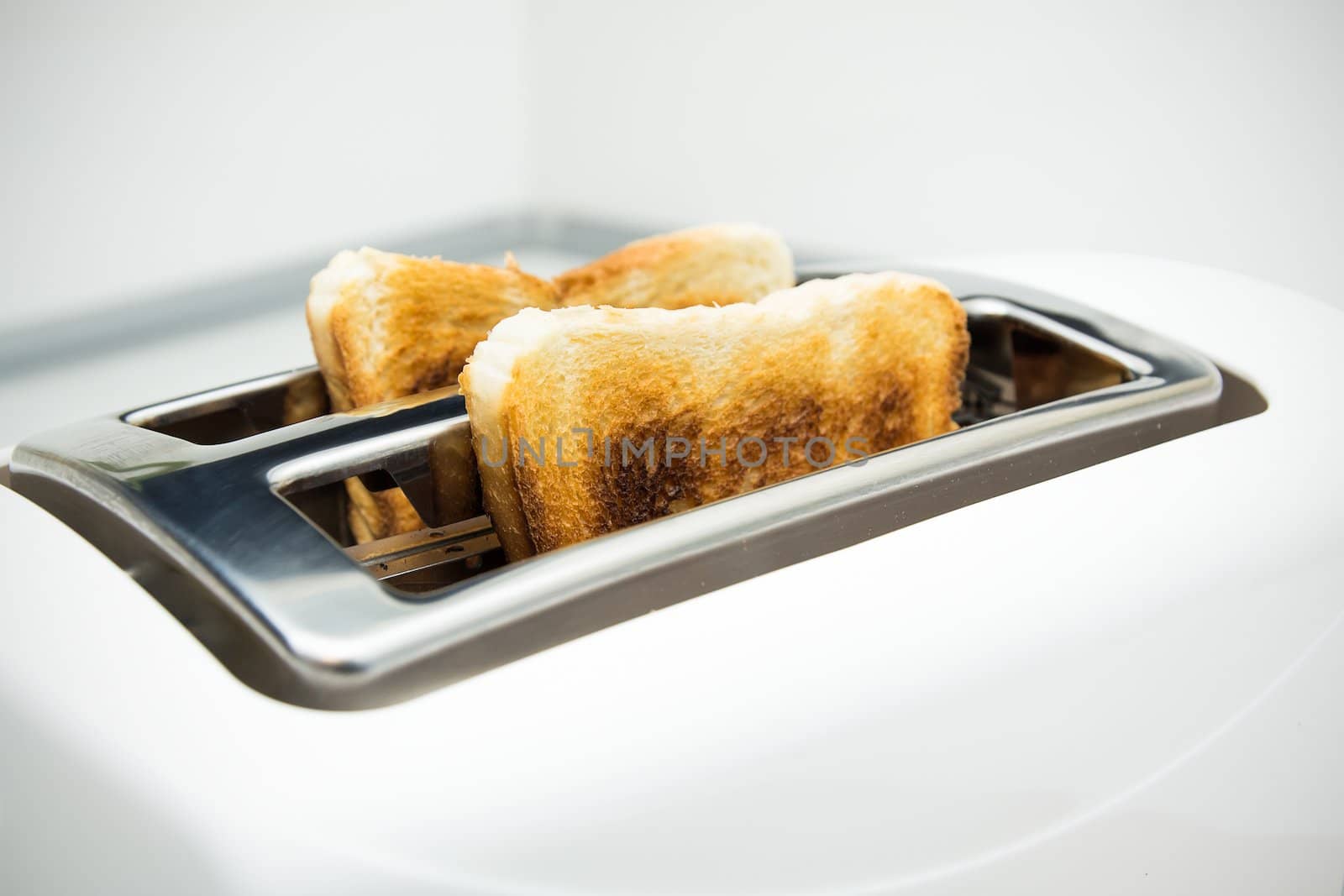 Toaster with bread slices on white background by simpson33