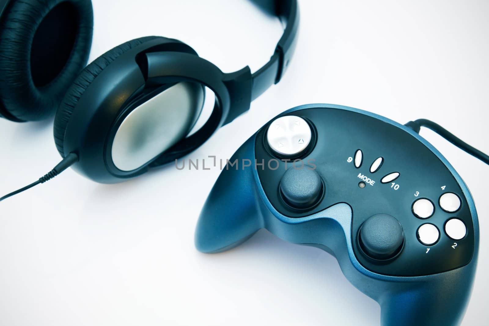 Gamepad and headphones on white background by simpson33