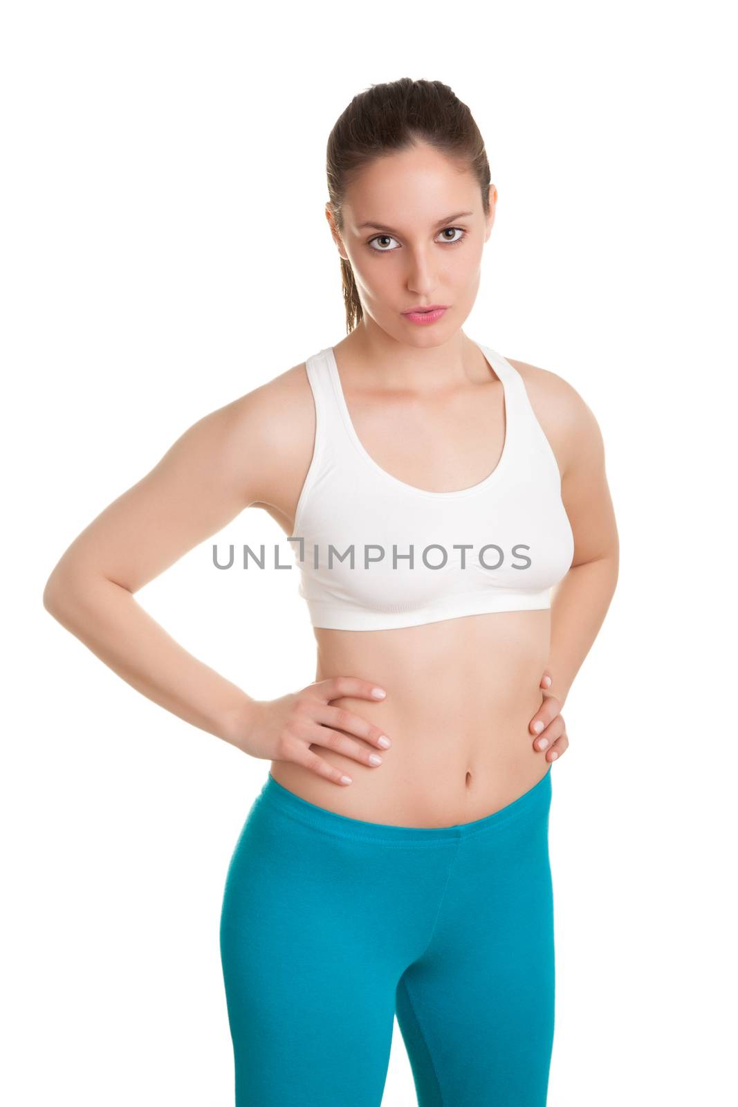 Fit woman standing and relaxing after a workout, isolated in white