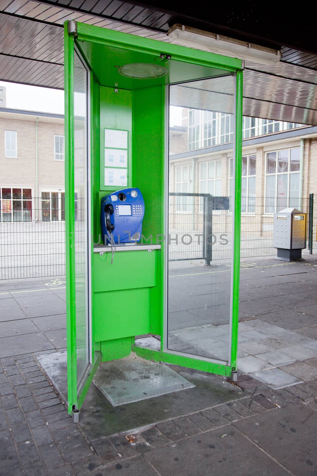 old green pay phone near amstel station in Amsterdam