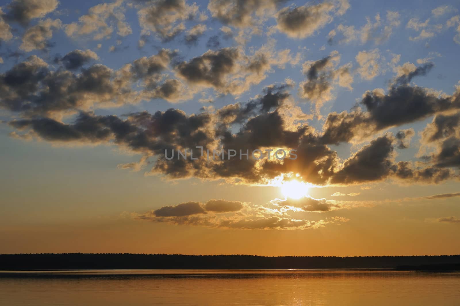 bright scenic sunset over lake's waters