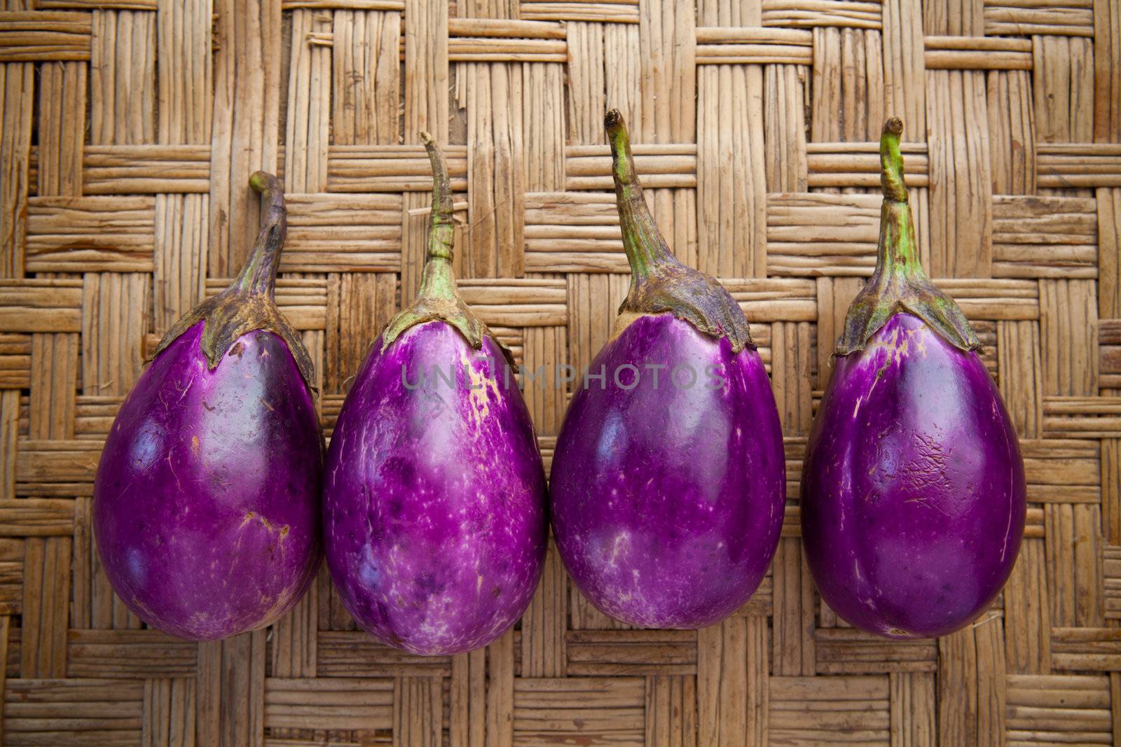 purple eggplant on bamboo craft  by khunaspix
