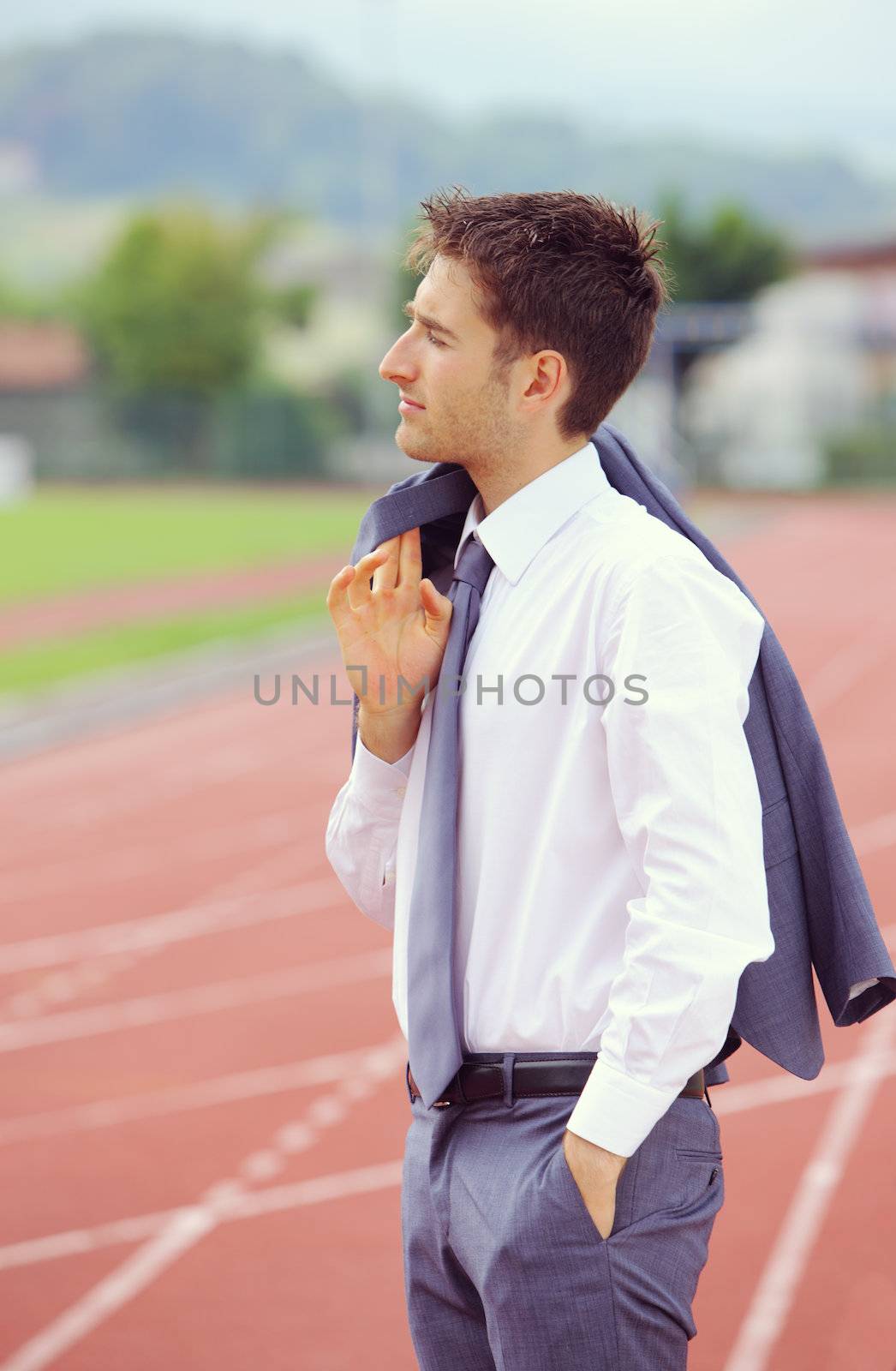 Football coach wearing a man's suit watching the match