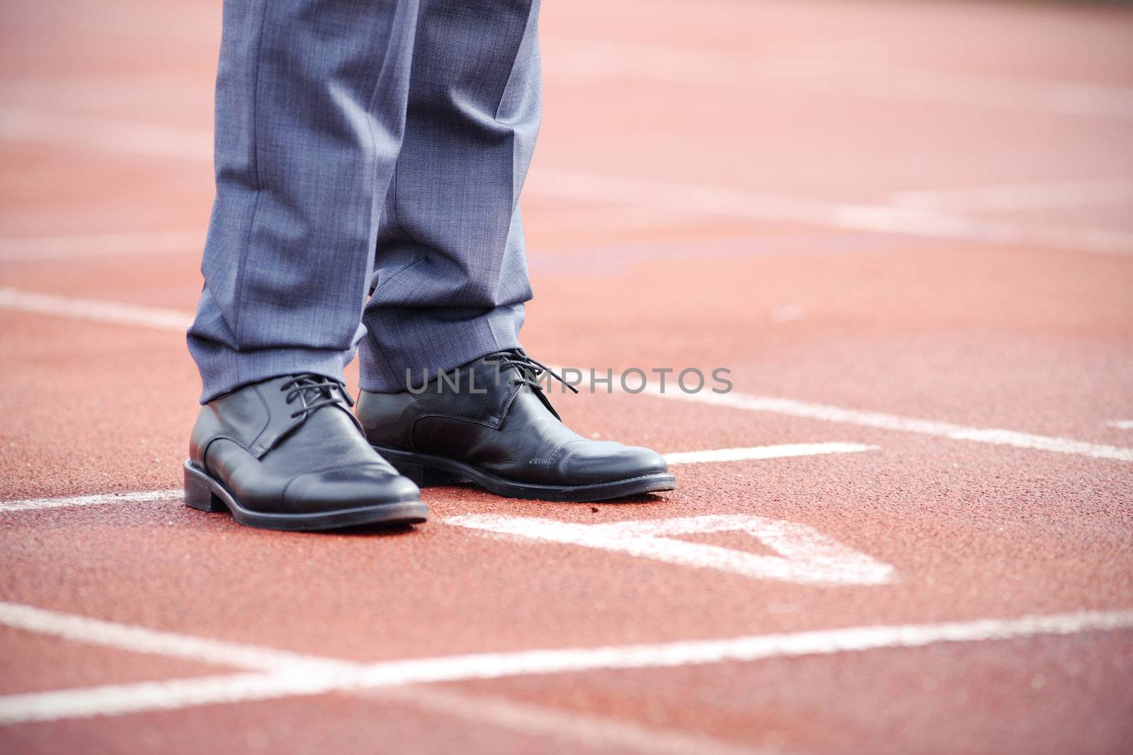 Businessman standing on the start line close up of shoes