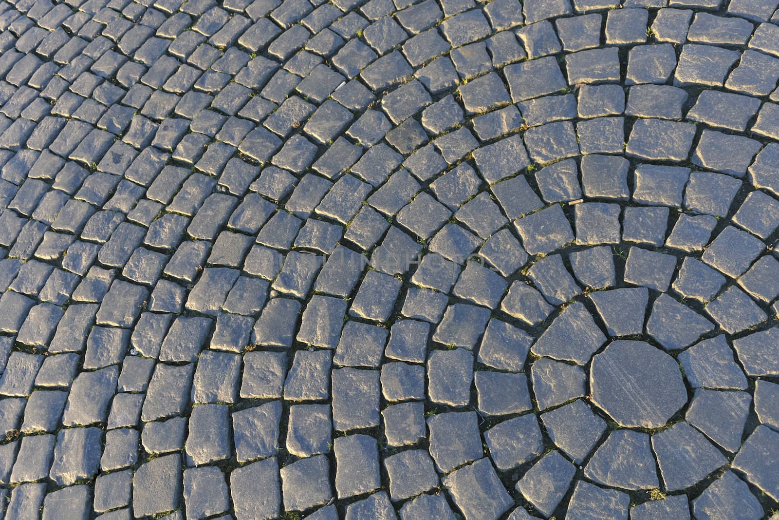Circular detailed patterns of cobblestone make up Palace Square in St. Petersburg