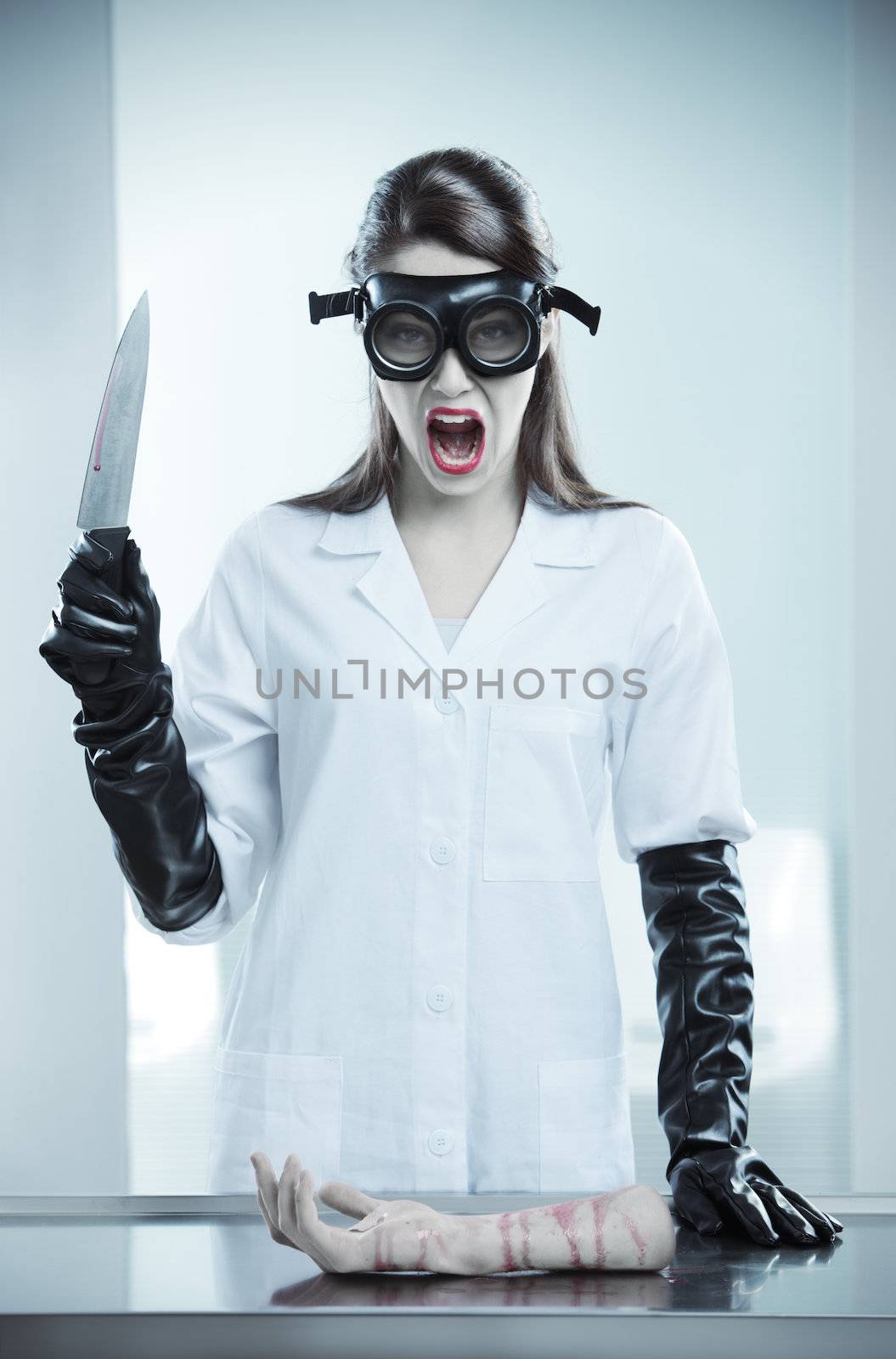 A terrifying doctor holding a knife and shouting