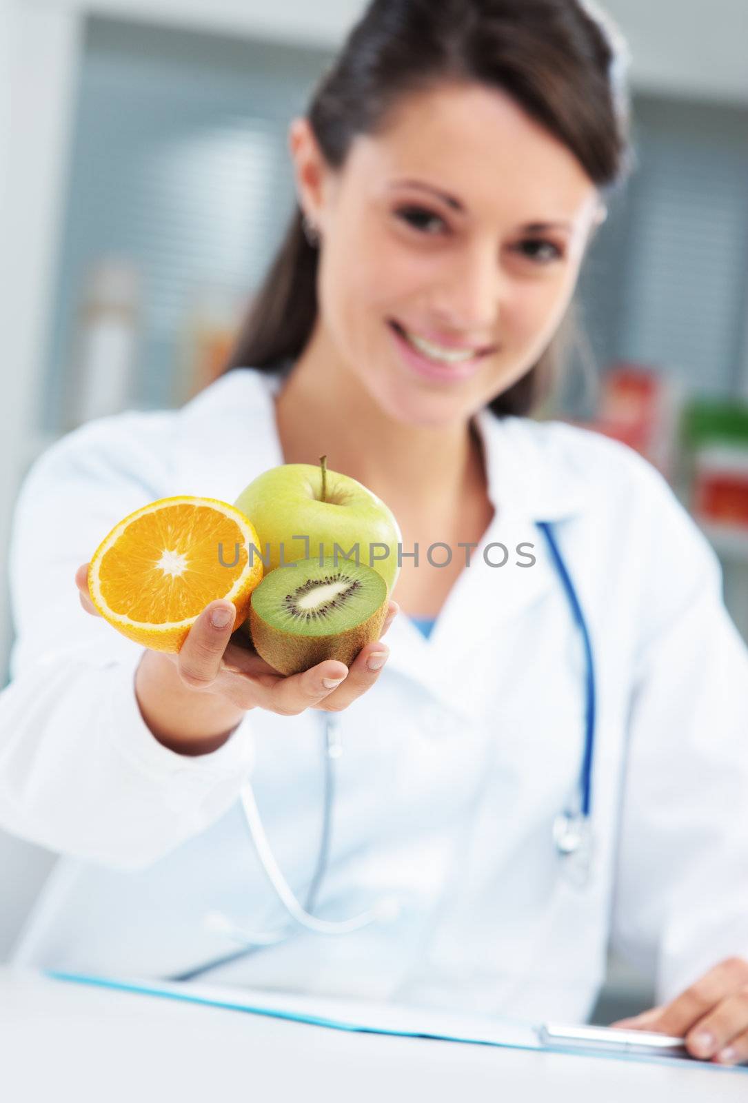 Nutritionist Doctor holding some fruits in her hand