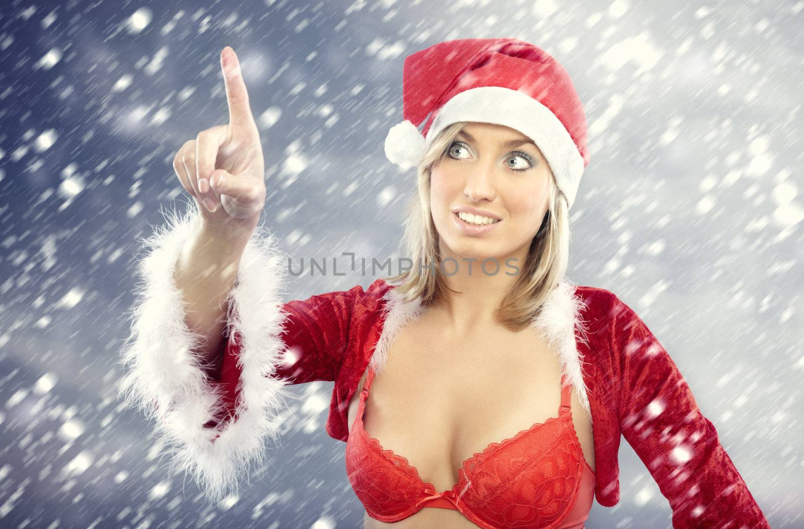 Smiling lady in the red Santa Claus costume under the heavy snowstorm reading Christmas snowy text