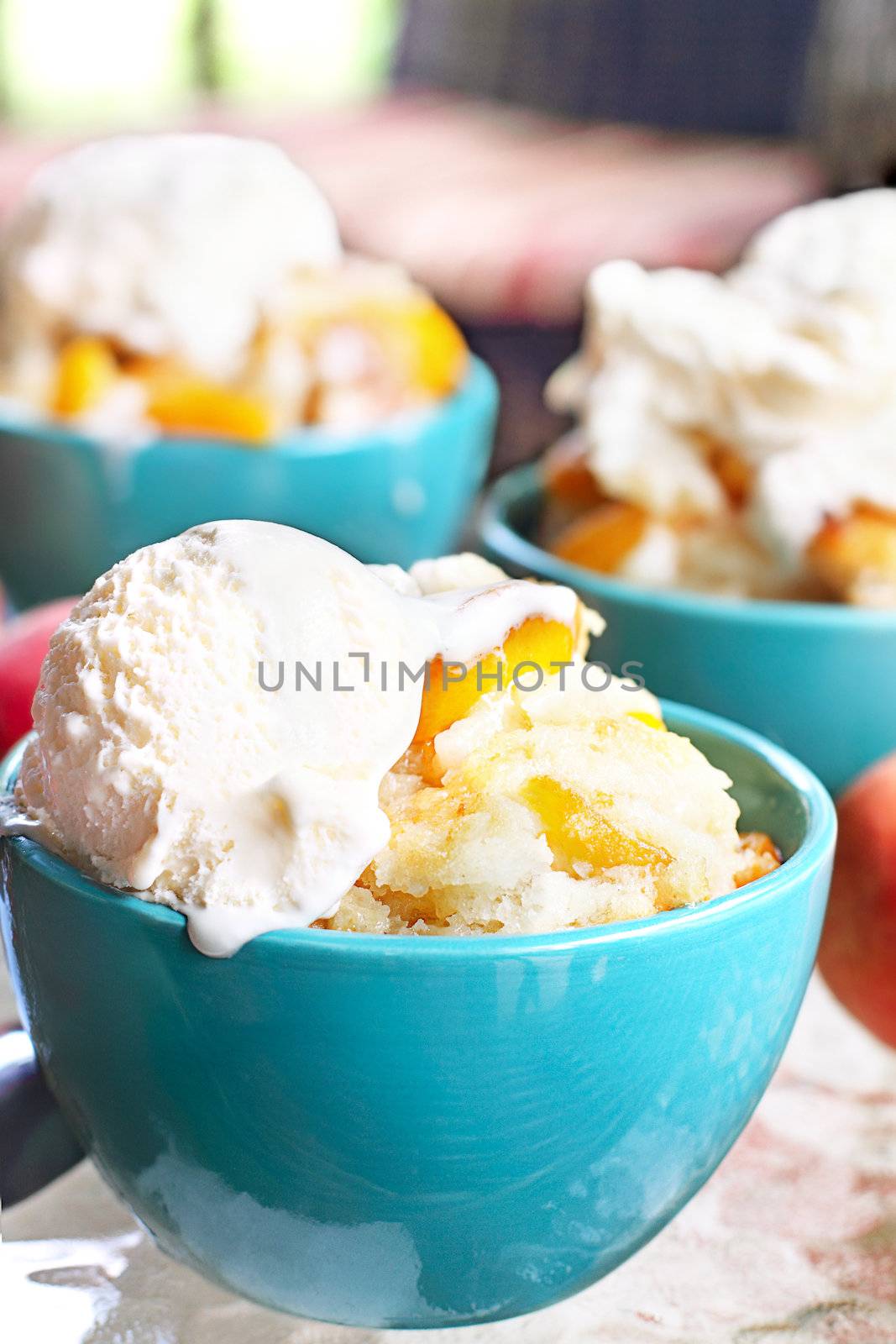 Fresh peach cobbler served with vanilla ice cream.