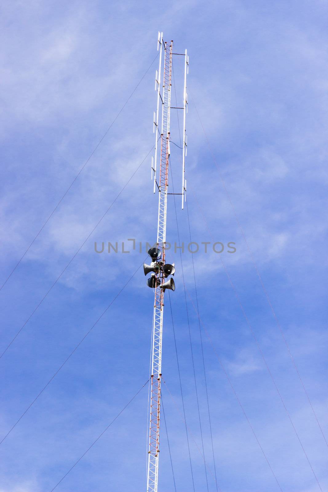 Radio antenna tower with loudspeaker and sky. by photo2life