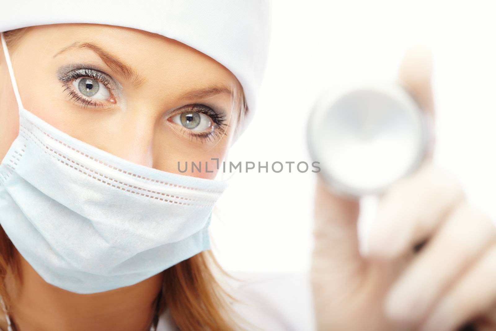 Doctor in protective mask and rubber gloves holding stethoscope