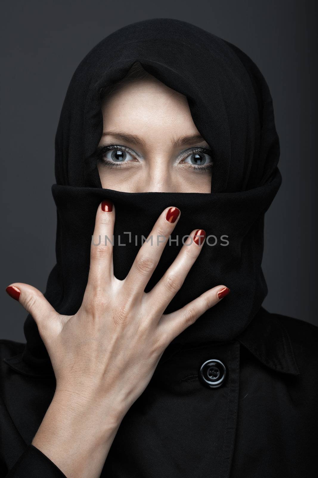 Woman in black ninja dress with manicure