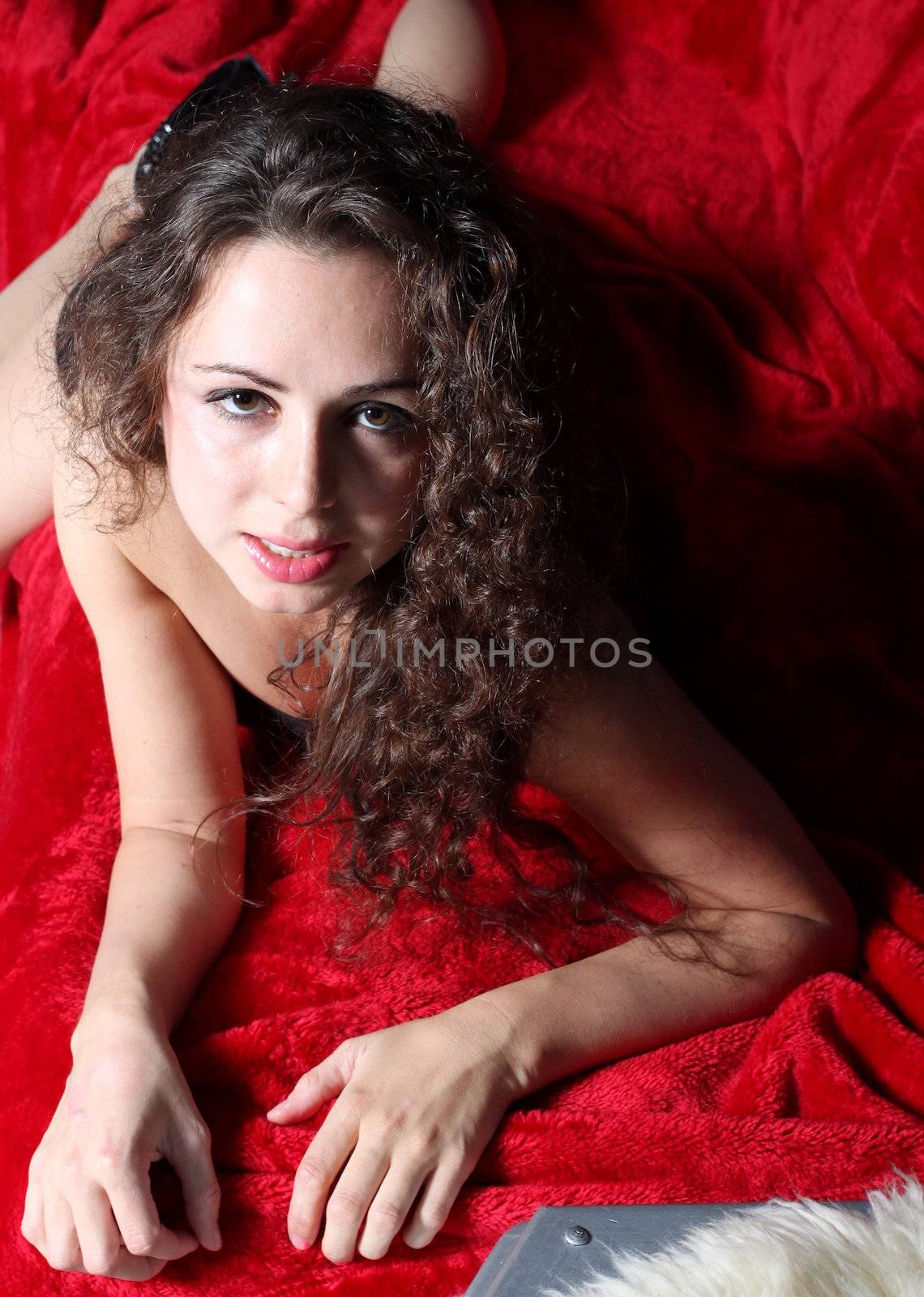 Portrait of a brunette woman on red.