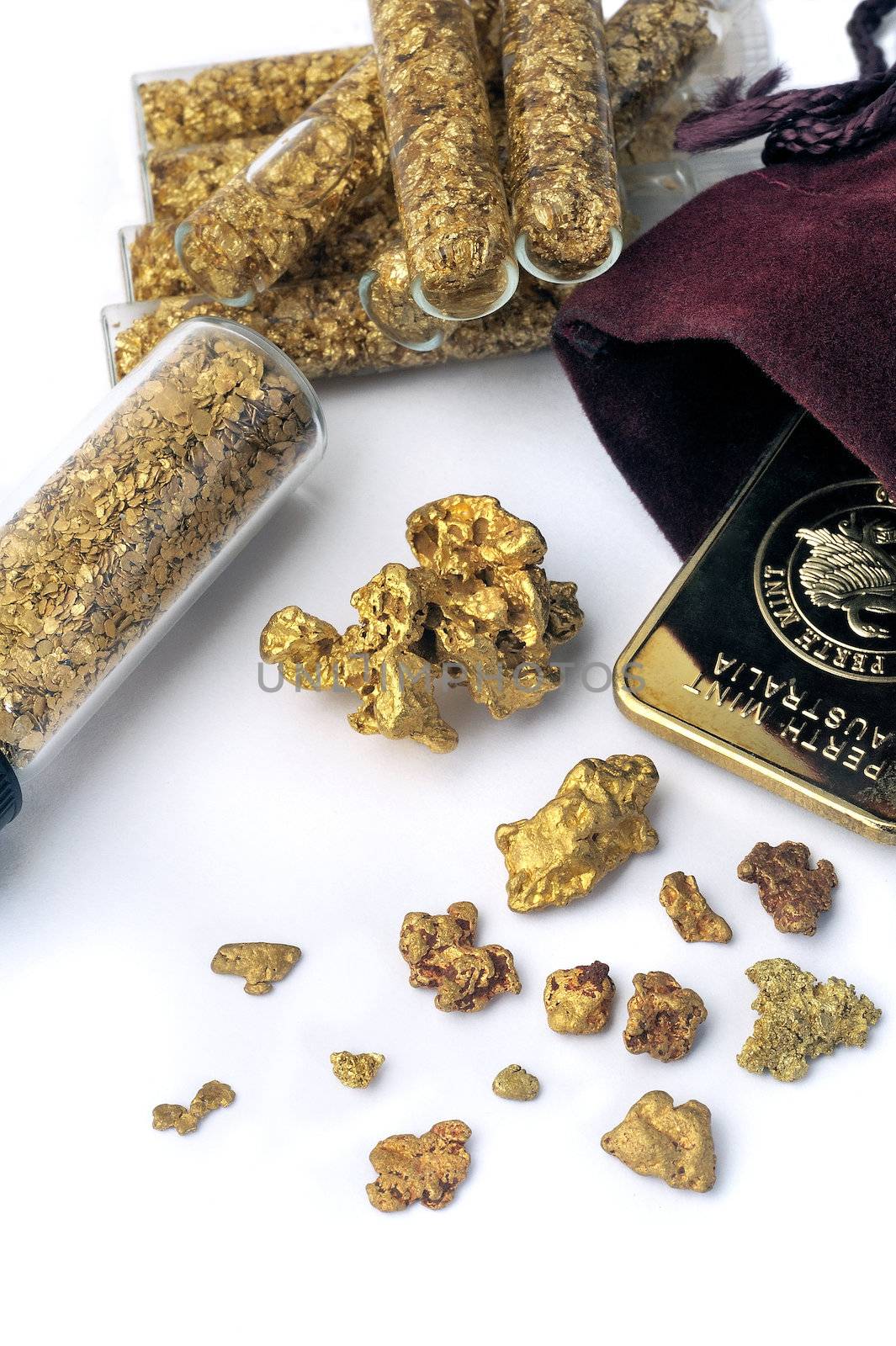 nuggets and gold bullion in studio on white background