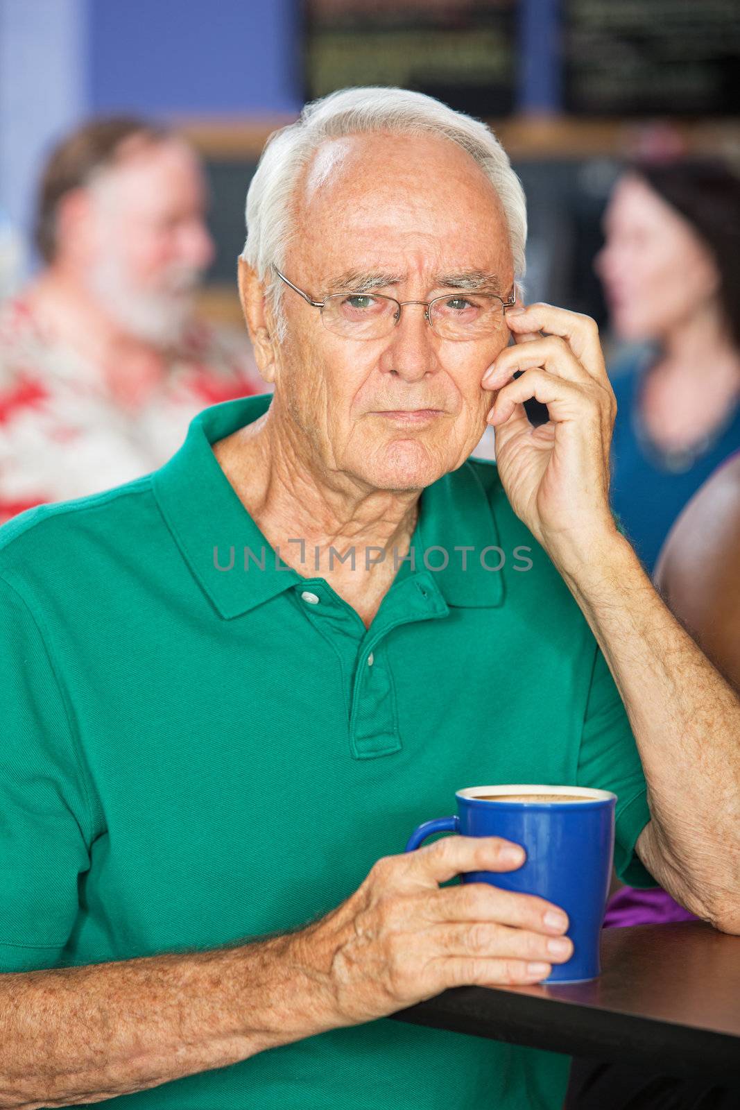 Thoughtful single senior male with coffee mug