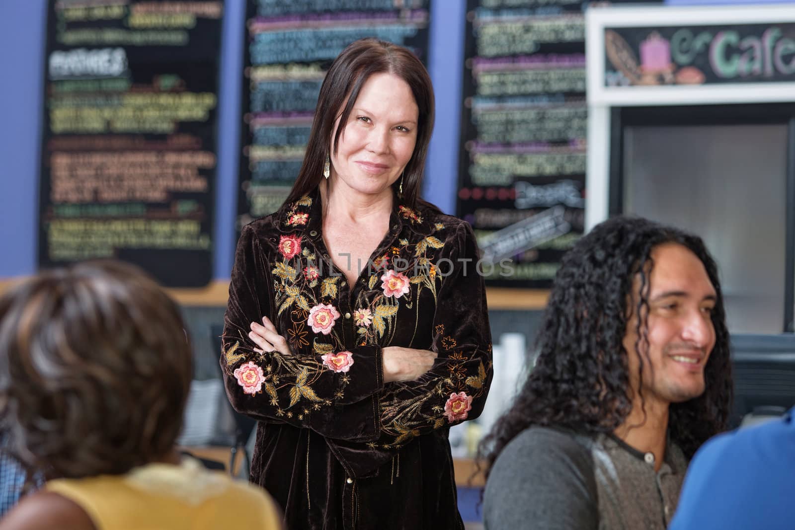 Beautiful mature woman standing in coffee house