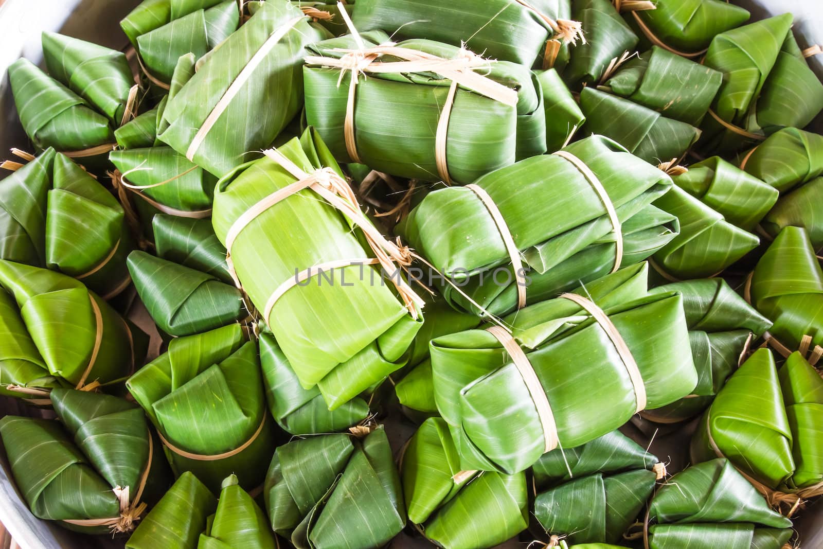 Khao tom mad is a Thai traditional dessert made from sticky rice, coconut milk, sugar , and bananas wrap with banana leaf.