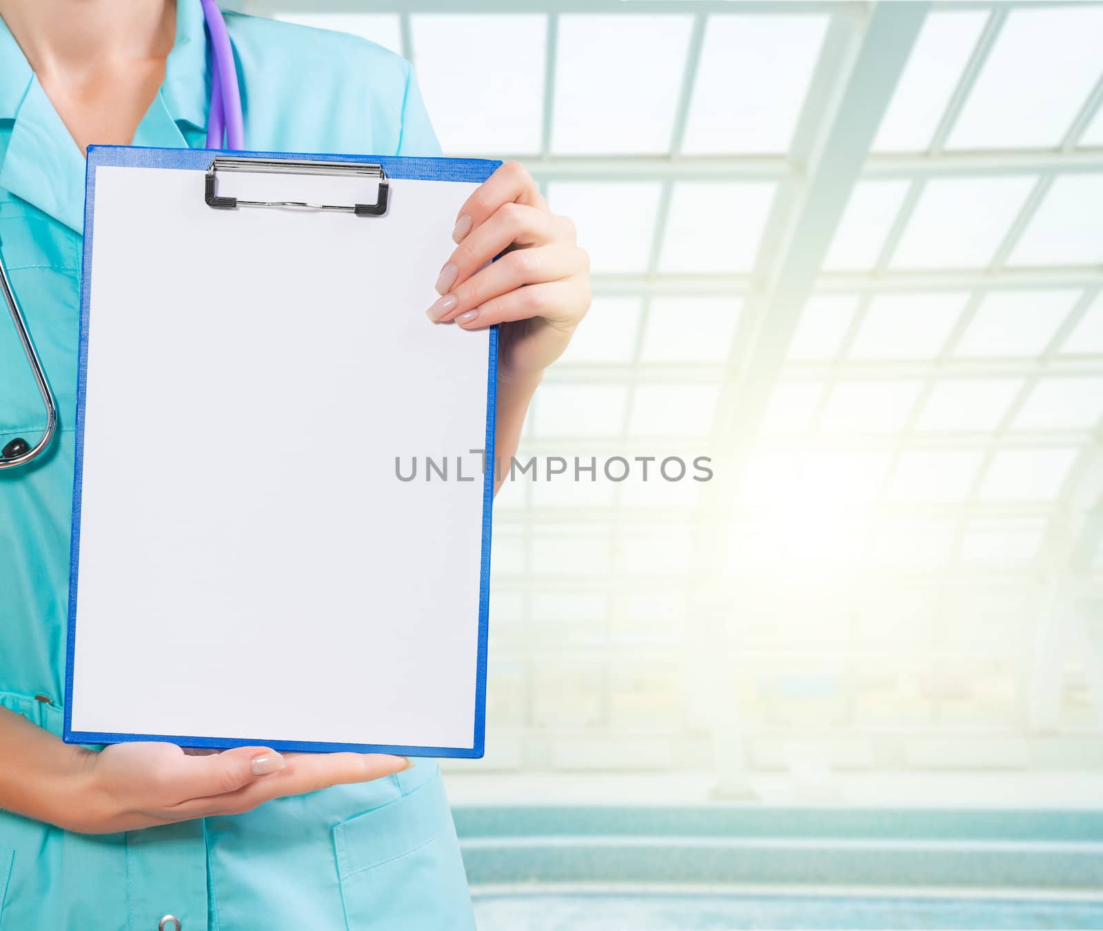 hands of female doctor holding clipboard