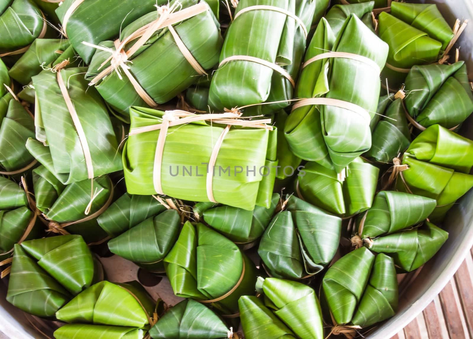 Khao tom mad is a Thai traditional dessert made from sticky rice, coconut milk, sugar , and bananas wrap with banana leaf.