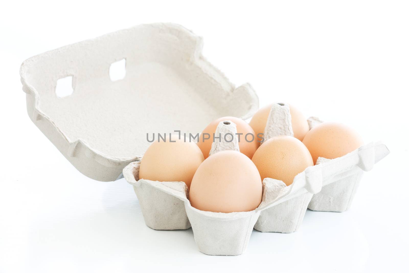 Six eggs on a carton box over white by simas2