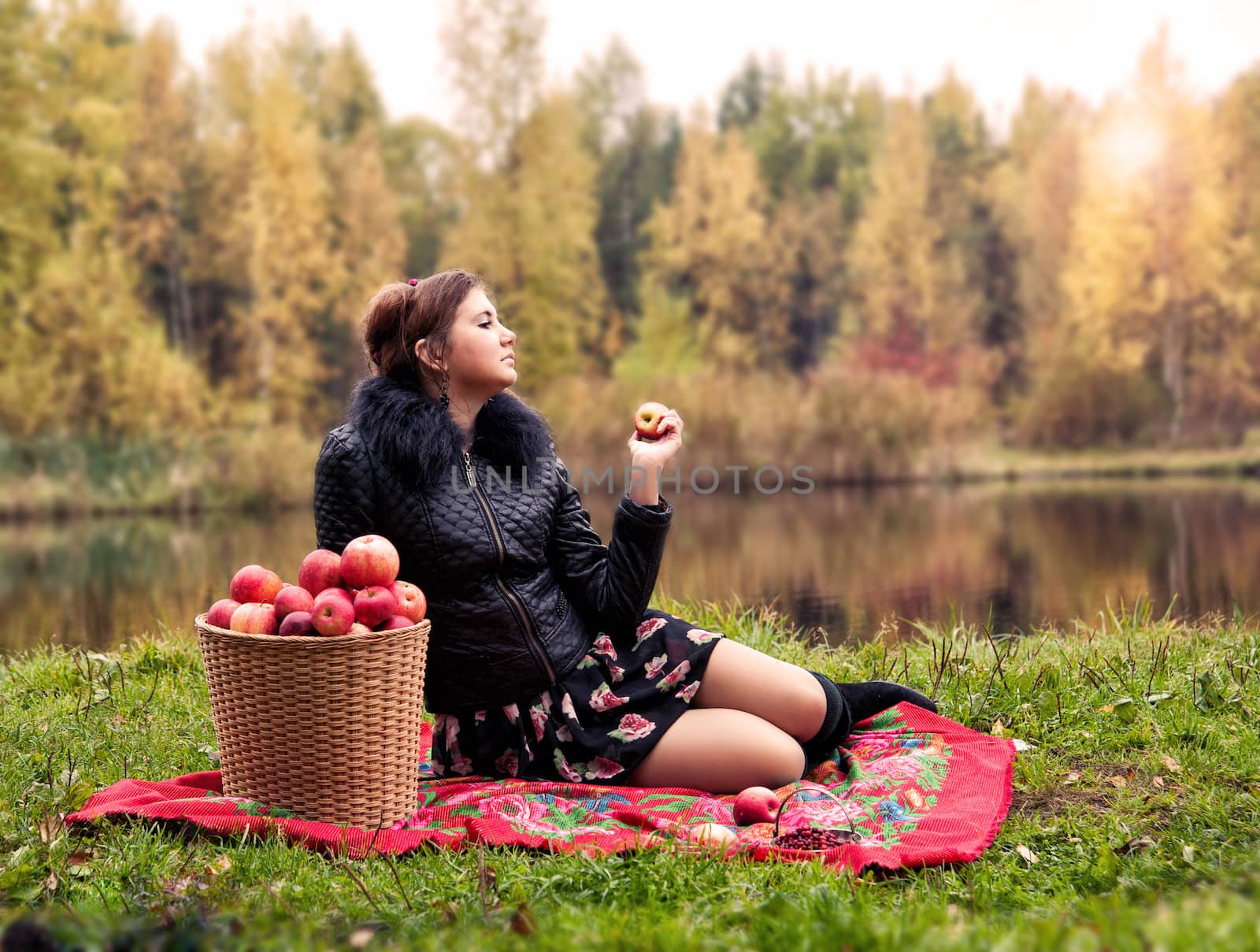haughty woman with a basket of apples on a picnic