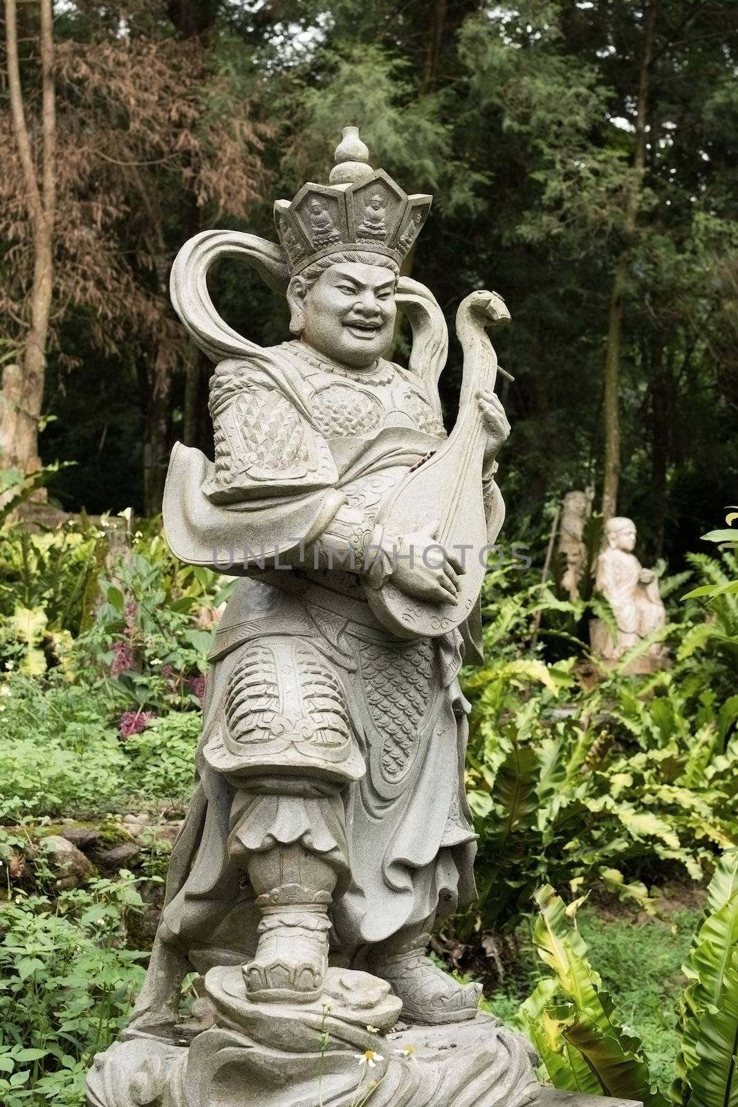 Aged asian god stone statue.