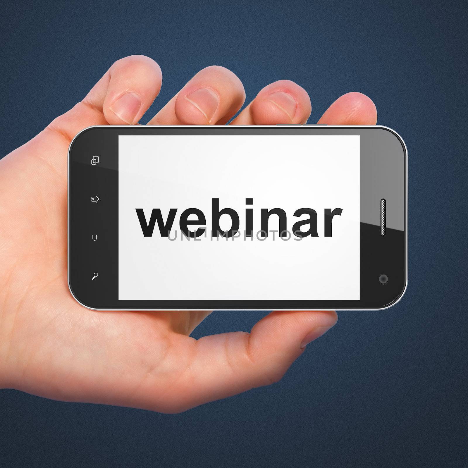 Education concept: hand holding smartphone with word Webinar on display. Generic mobile smart phone in hand on Dark Blue background.