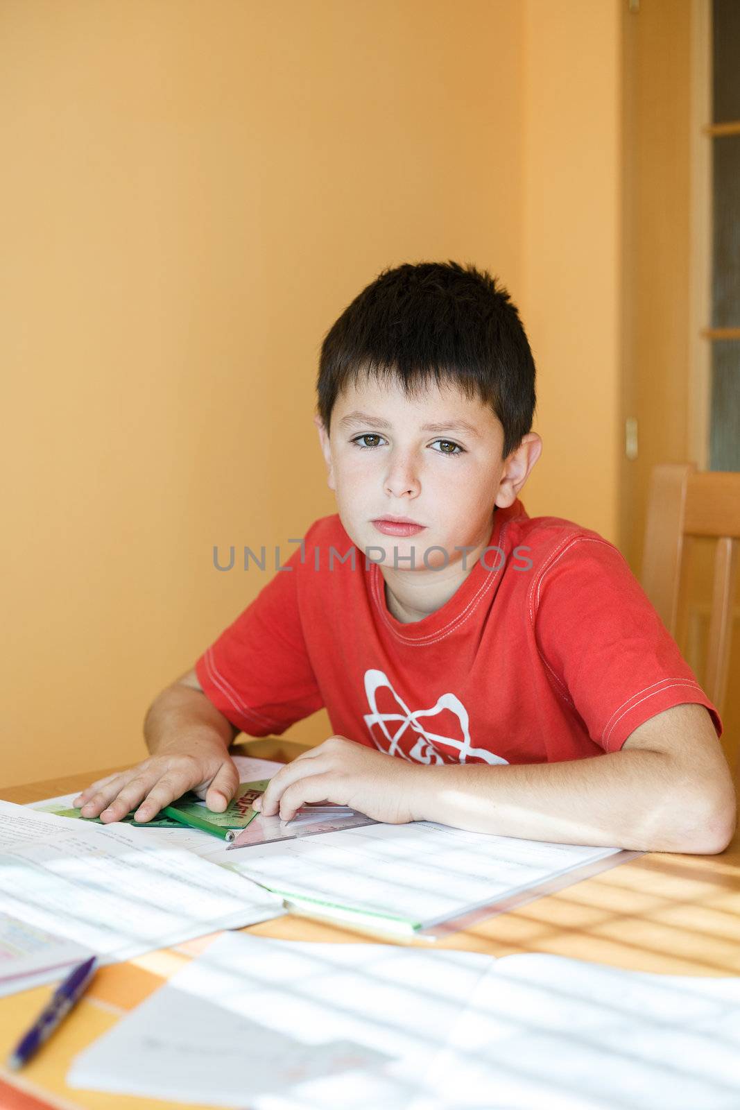 boy doing school homework from geometry mathematics in workbook