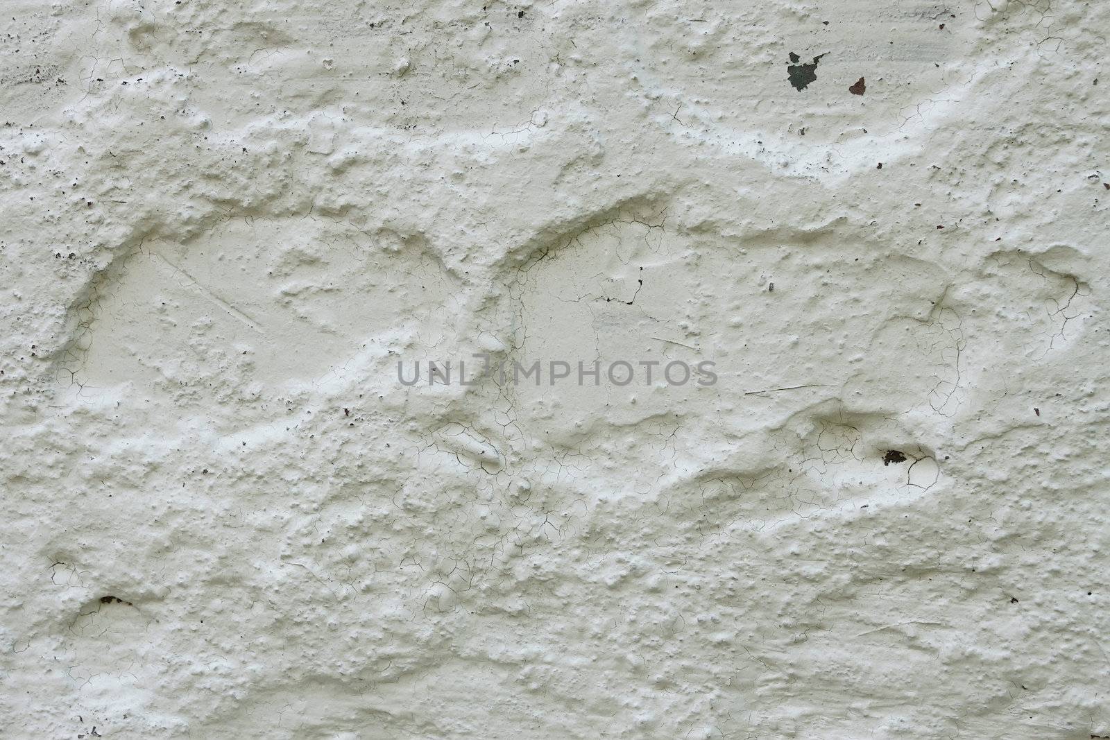 Fragment of old concrete wall whitewashed with lime