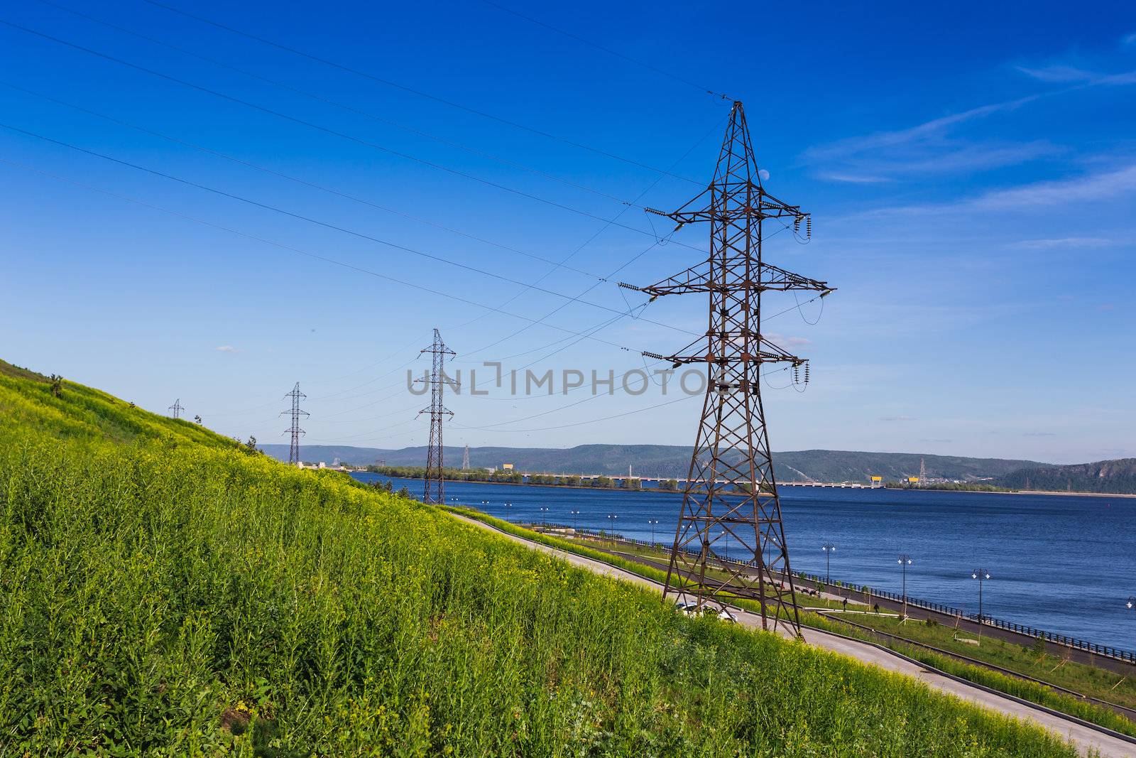 High-voltage power line on the shore of the river